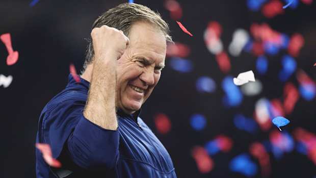Bill Belichick pumps his fist as confetti falls behind him